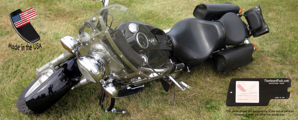 Harley Davidson bike laid over on grass